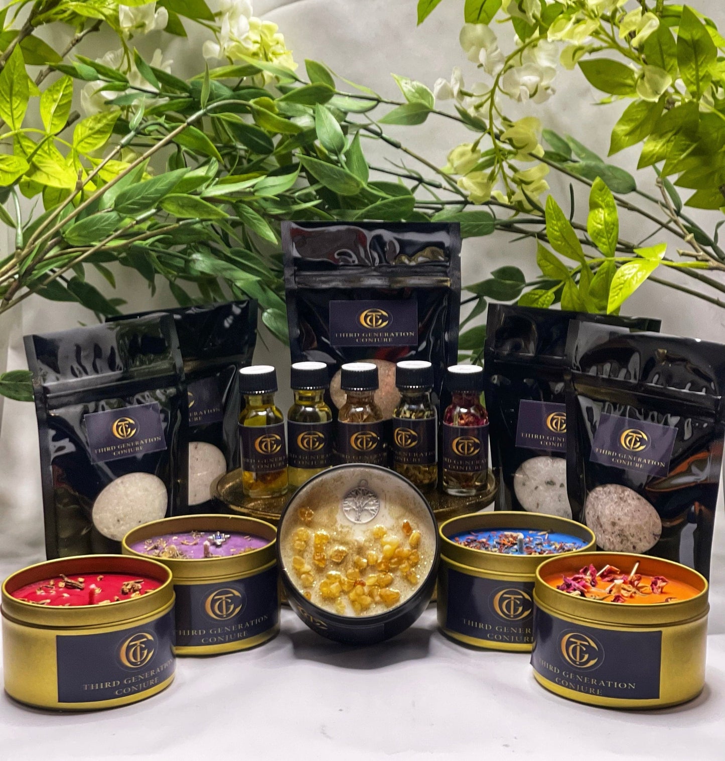 Photo of black bags with Epsom salt and product label of third generation conjure, bottles of oil with assorted herbs and candles in gold tins dressed with various herbs 
